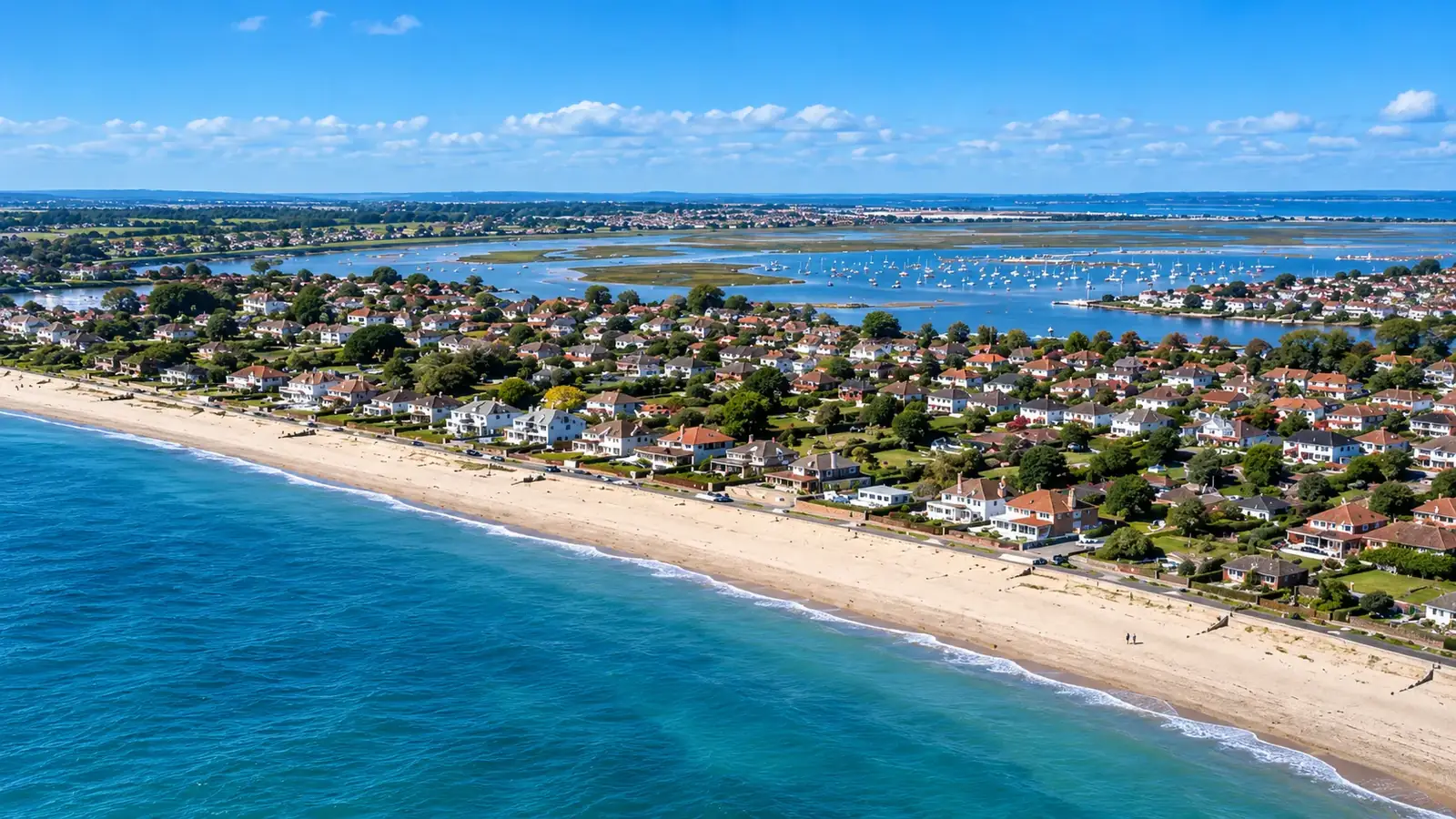 Aerial view of Hayling Island coastline, beach and harbour with Welcome to Hayling Island sign